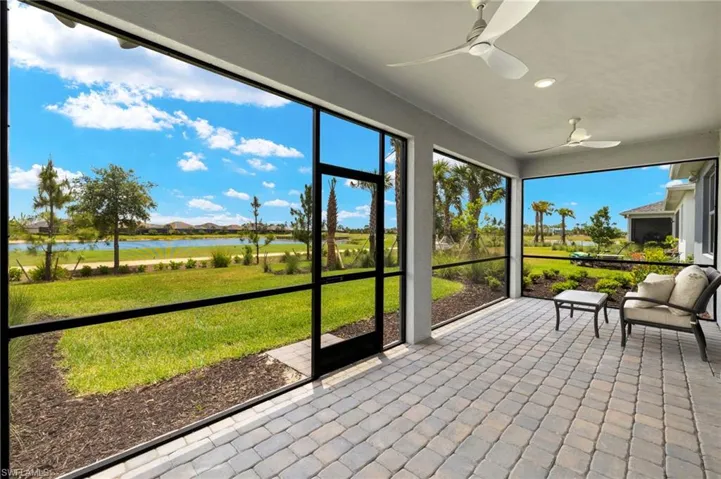 Sunroom / solarium with a water view and ceiling fan