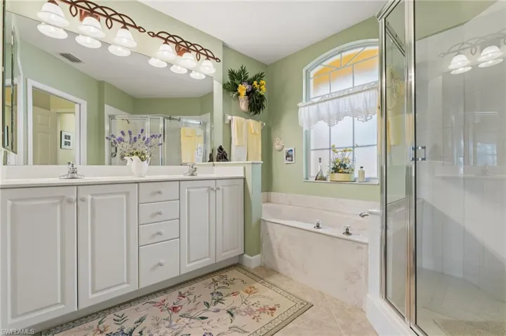 Primary bathroom with soaking tub and shower.