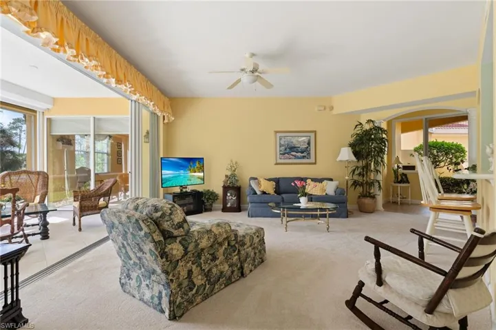 Living room features an abundance amount of natural lighting, with new carpeting.