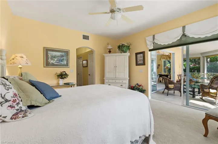 Large primary bedroom  features slider for direct access to lanai area