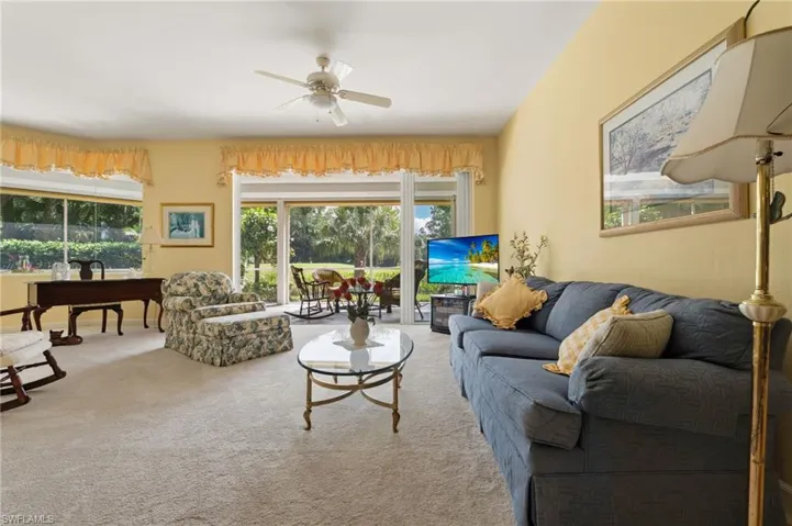 Living room features an abundance amount of natural lighting, with new carpeting.