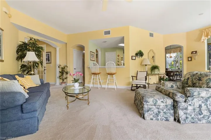 Large open space with view to kitchen with counter seating.