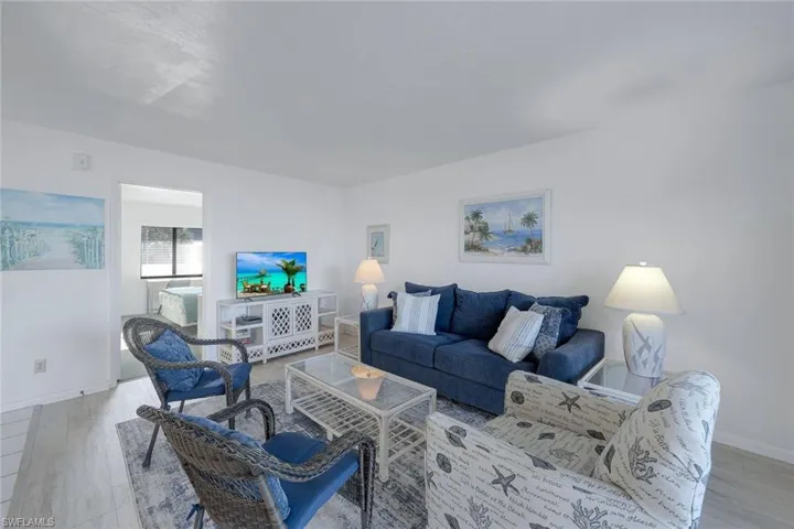 Living room with baseboards and light wood-type flooring