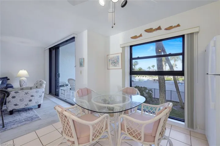 Dining area featuring light tile patterned flooring and a ceiling fan