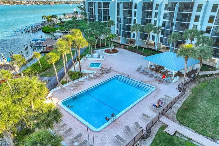Community pool featuring a patio and a water view