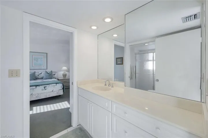Ensuite bathroom with visible vents, a shower stall, recessed lighting, vanity, and ensuite bath