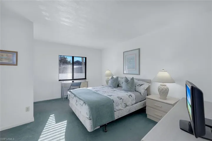 Carpeted bedroom with baseboards