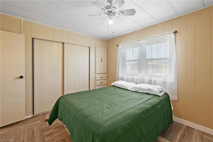 Bedroom with a closet, a ceiling fan, and a decorative wall