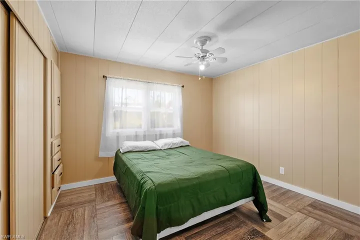 Bedroom featuring baseboards, a ceiling fan, and a textured ceiling