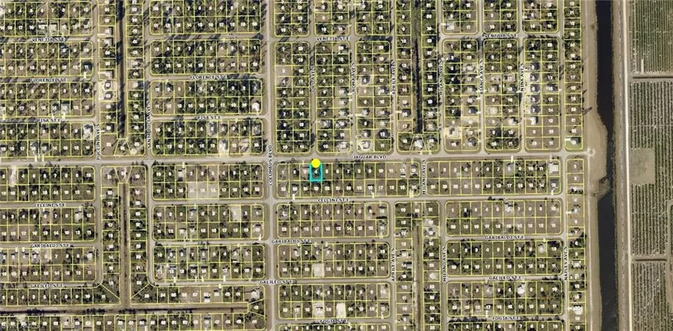 Aerial Map. Illustrating the property's location within a residential grid and its proximity to a canal and agricultural area