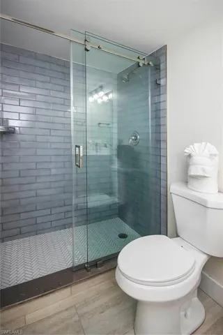 Bathroom with wood finished floors and a stall shower