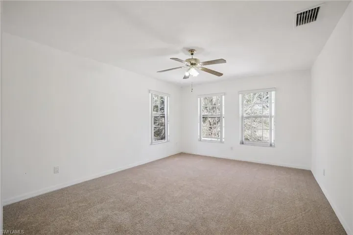 Bedroom 3 featuring healthy amount of natural light, light carpet, and ceiling fan
