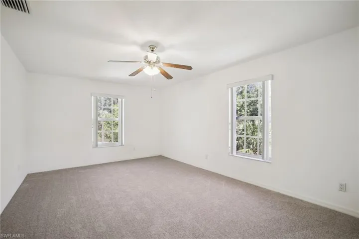 Carpeted bedroom 2 featuring healthy amount of natural light and a ceiling fan