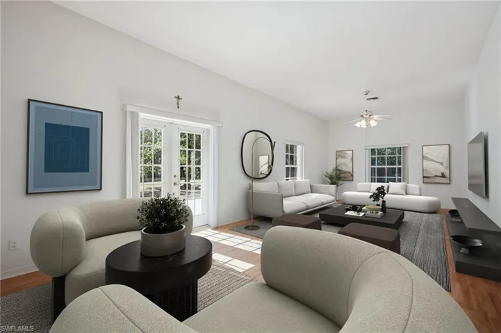 VIRTUALLY Staged Living room with wood laminate floors, French doors, and healthy amount of natural light