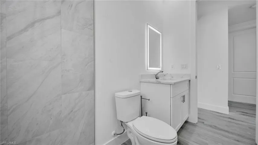 Full bathroom featuring vanity and light wood-style flooring