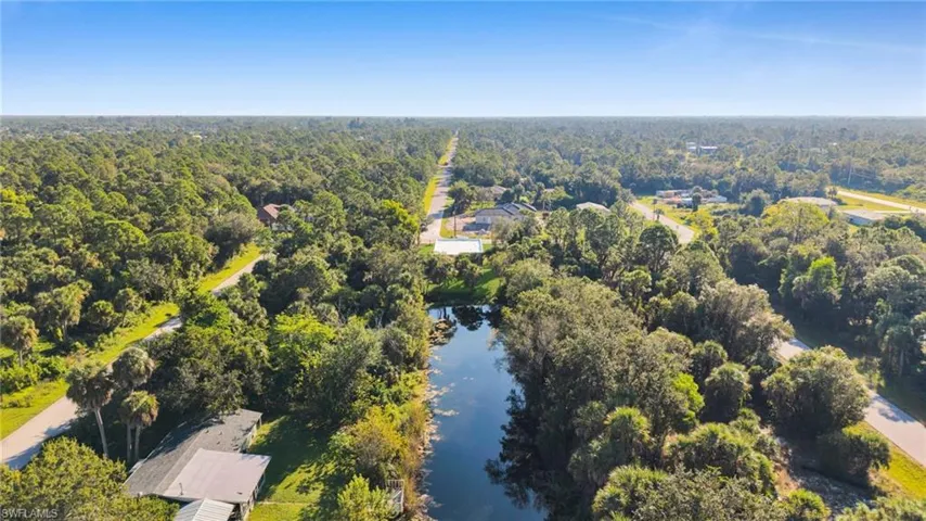Bird's eye view of a heavily wooded area and a large body of water