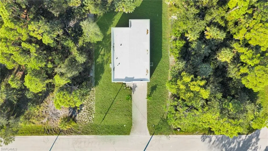 View from above of property featuring a tree filled landscape