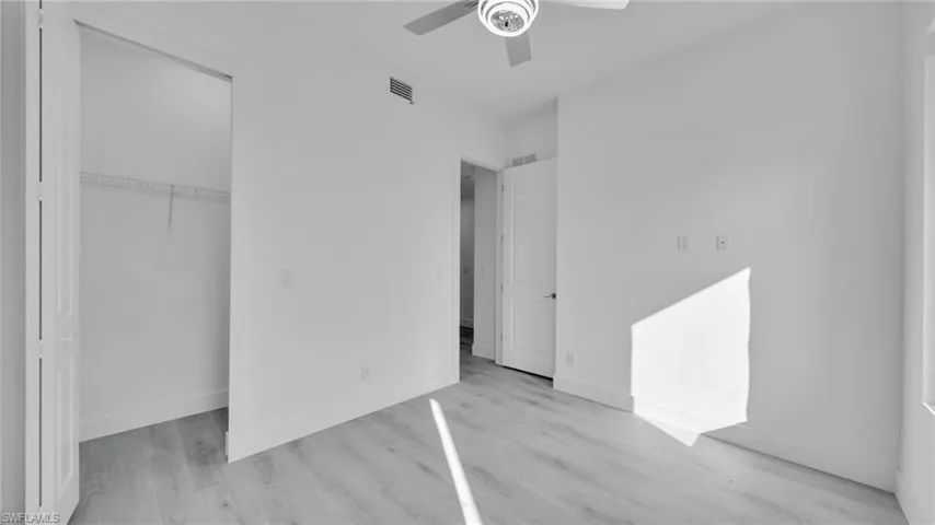 Unfurnished bedroom featuring light wood-style flooring, a ceiling fan, and a closet