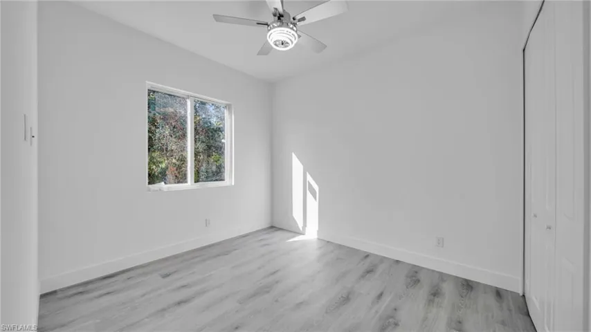 Unfurnished bedroom with a closet, light wood-type flooring, and ceiling fan