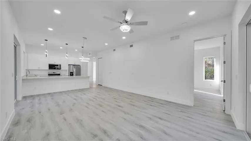 Unfurnished living room featuring recessed lighting, light wood-style flooring, and ceiling fan