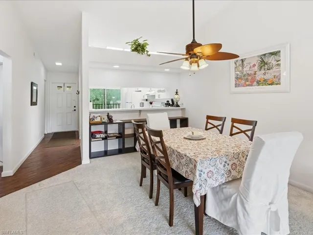 Dining room with light colored carpet, a ceiling fan, and recessed lighting