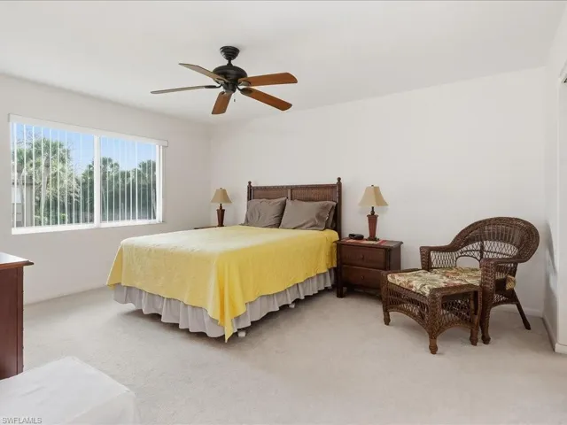 Bedroom featuring light colored carpet and ceiling fan