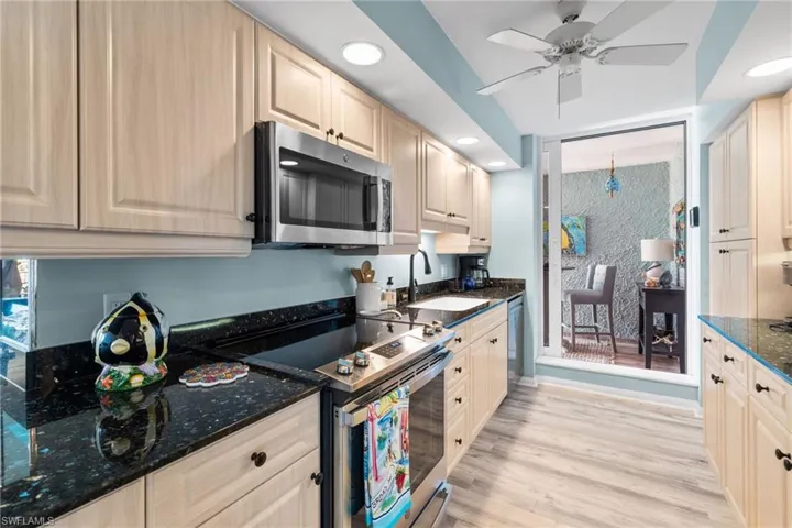 Kitchen featuring recessed lighting, a ceiling fan, appliances with stainless steel finishes, a sink, and light wood-style floors