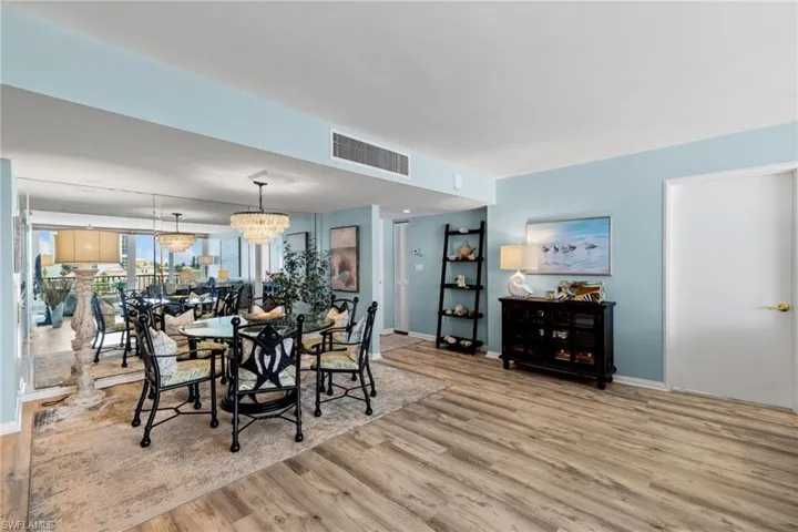 Dining room featuring wood finished floors, baseboards, and visible vents