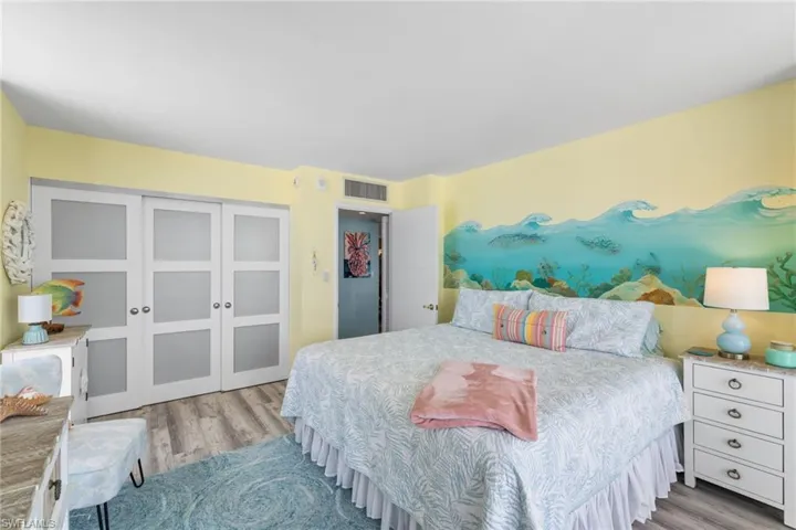 Bedroom featuring wood finished floors, a closet, and visible vents
