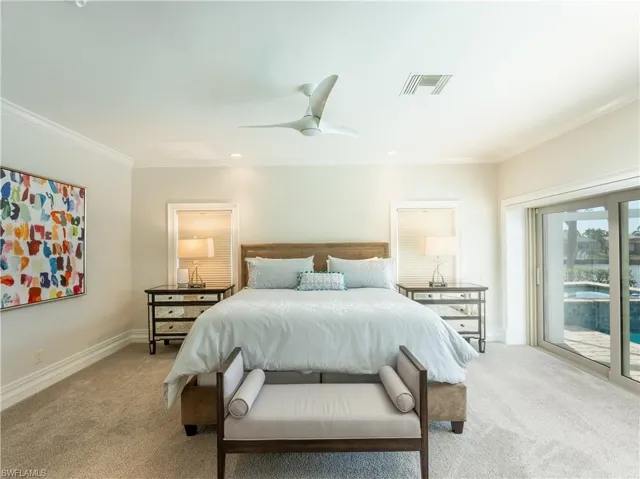 Bedroom featuring access to exterior, ornamental molding, light carpet, and ceiling fan