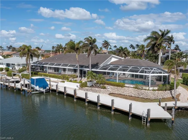 View of dock featuring a water view and a lanai