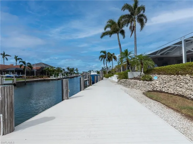 Dock area with a water view and a lanai