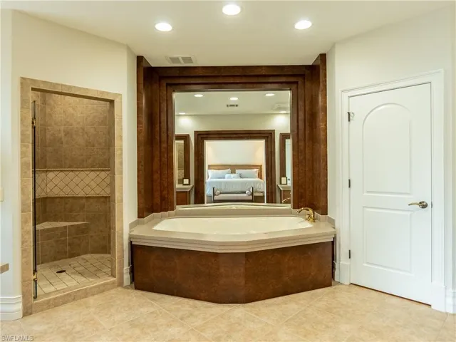Bathroom featuring walk in shower and tile patterned flooring