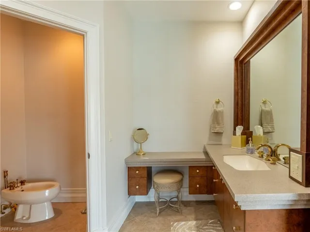 Bathroom featuring vanity, a bidet, and tile patterned flooring