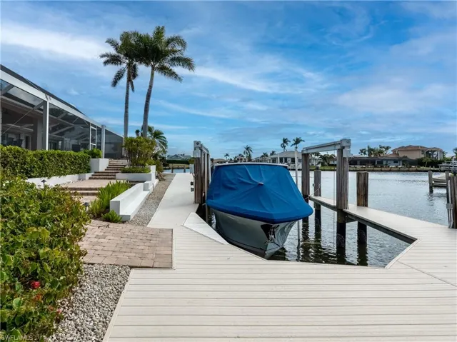 View of dock with a water view and a lanai