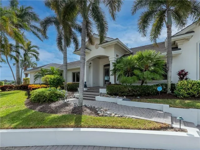 Mediterranean / spanish house with a front lawn