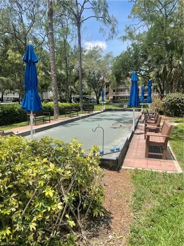 View of swimming pool with a bocce ball area