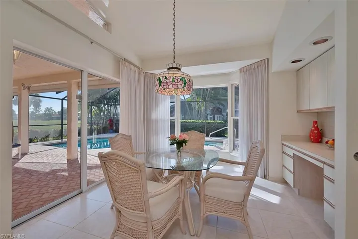 Dining space featuring plenty of natural light and light tile patterned floors, and desk area
