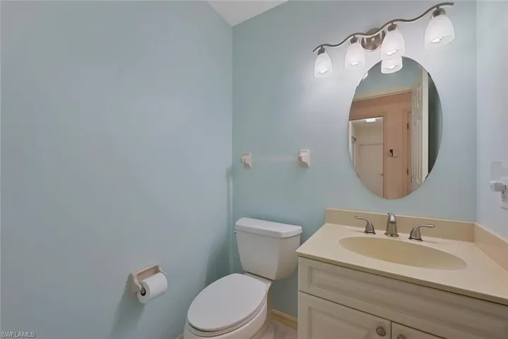 1/2 Bathroom with vanity and toilet