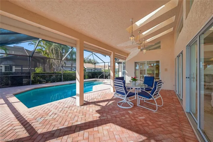 Skylights above, in lanai area with view of swimming pool with a lanai and a patio area