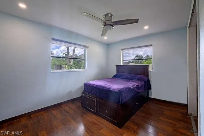 Bedroom featuring dark hardwood / wood-style flooring and ceiling fan