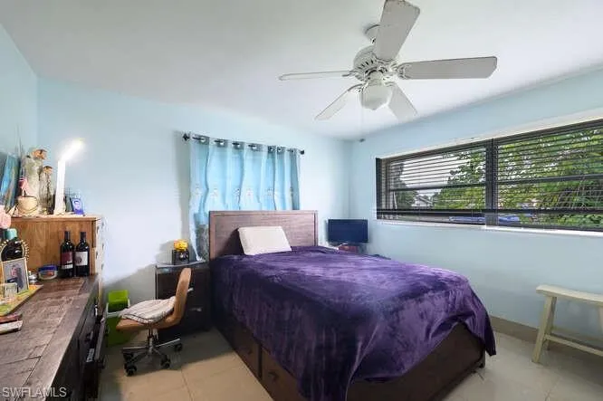 Bedroom featuring light tile patterned floors and ceiling fan