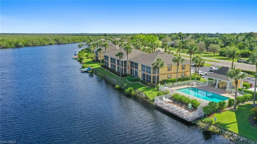 Bird's eye view of a nearby body of water and a pool area