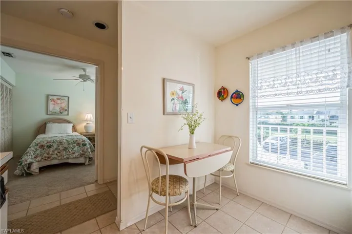 Dining room with light tile patterned floors and a ceiling fan