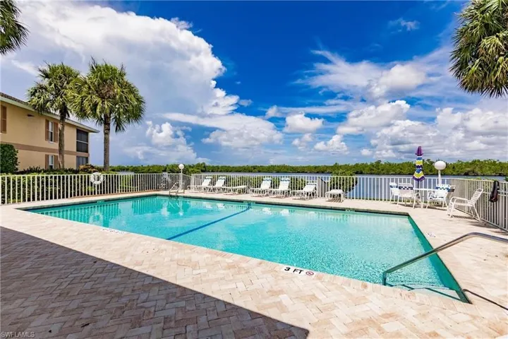 Community pool with a patio