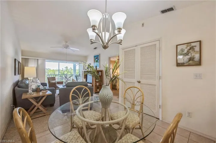 Dining area with ceiling fan and a chandelier