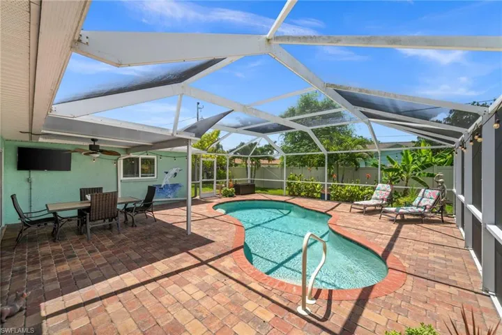 Pool area and covered lanai surrounded by pavers