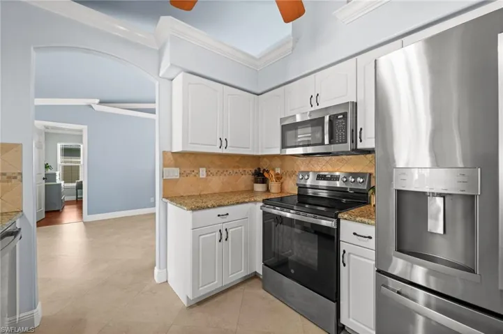 Tile backsplash and crown molding throughout