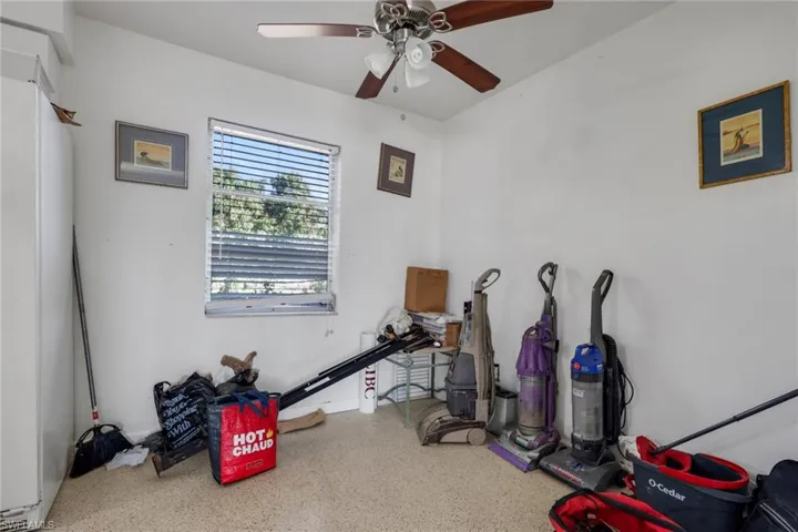 Recreation room featuring speckle patterned floor and ceiling fan