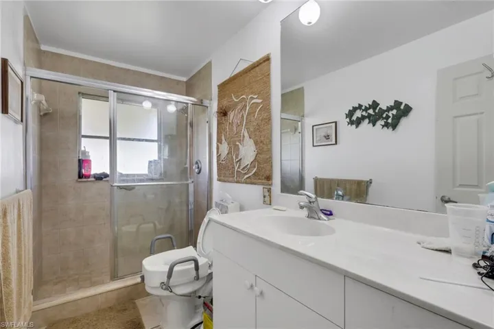 Full bathroom with vanity and a stall shower